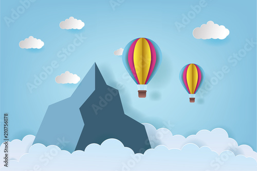 Origami made colorful hot air balloon flying over the mountain with cloud.Paper art style. Landscape vector illustration. Mountain background illustration.