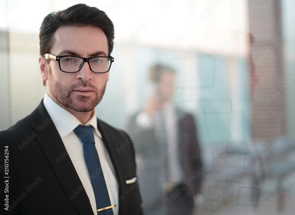 close up. serious businessman on the background of the office close up. serious businessman on the background of the office