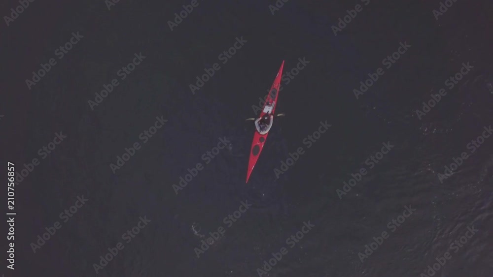 Overhead aerial, person kayaks in San Juan Islands Overhead aerial, person kayaks in San Juan Islands