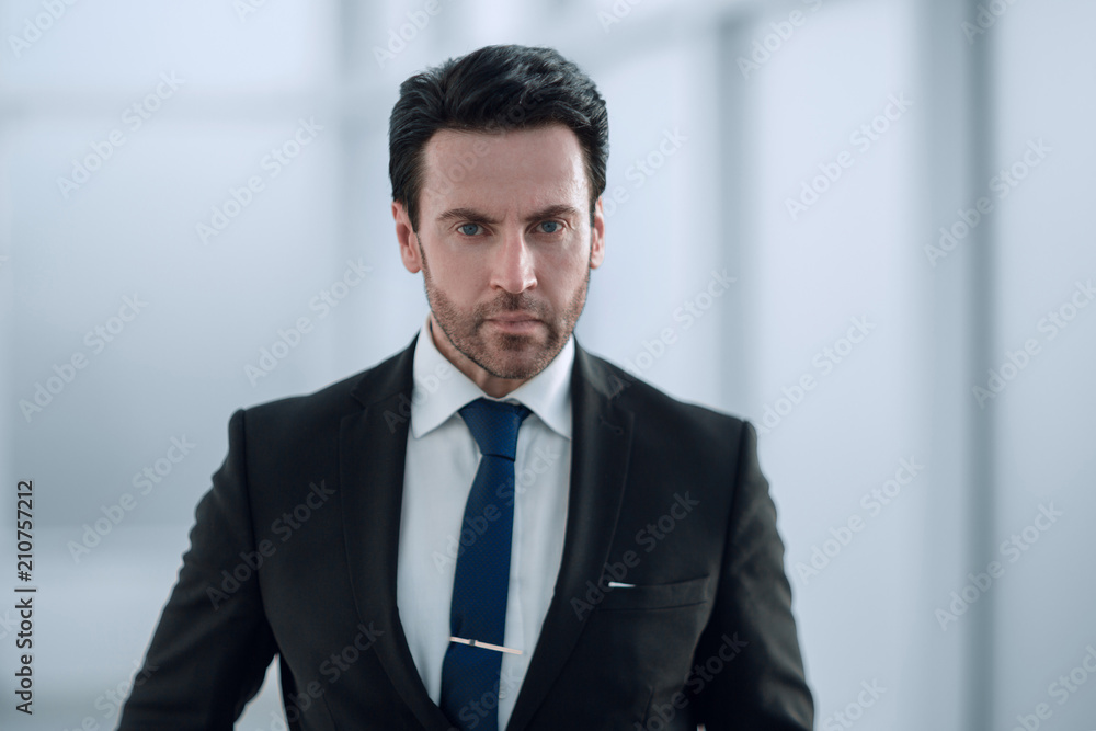 serious businessman on the background of the office window serious businessman on the background of the office window