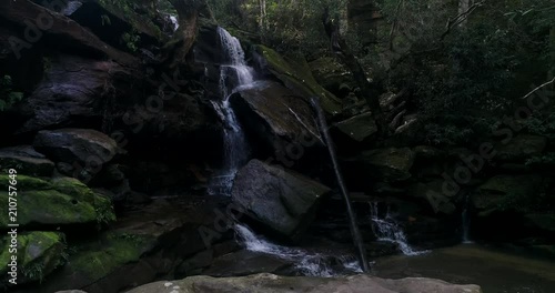 Sandstone rocks and boulders in a way of Somersby waterfalls under thick tree crowns of evergreen rain forest on the Central coast.
 photo