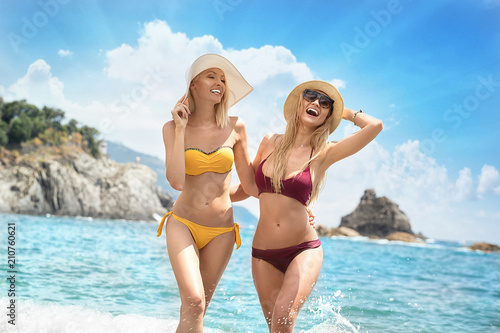 Two caucasian women having fun on the beach.