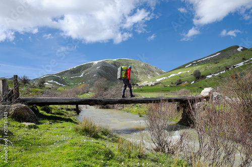 Hiker Crossing Bridge Over Creek In Nebrodi Park, Sicily photo