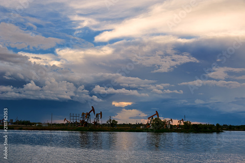 The oil pumping units and cloudscape sunset.