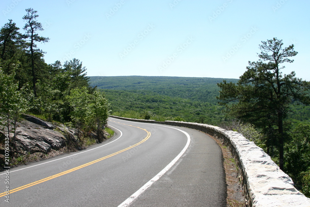 Turning road overlooking green hills