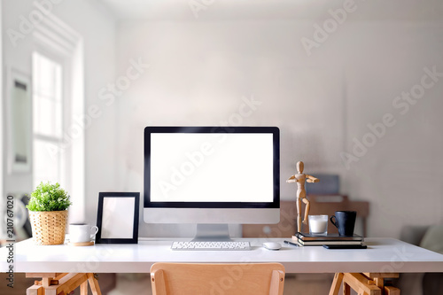 Creative entrepreneur workspace with desktop computer and supplies. © bongkarn