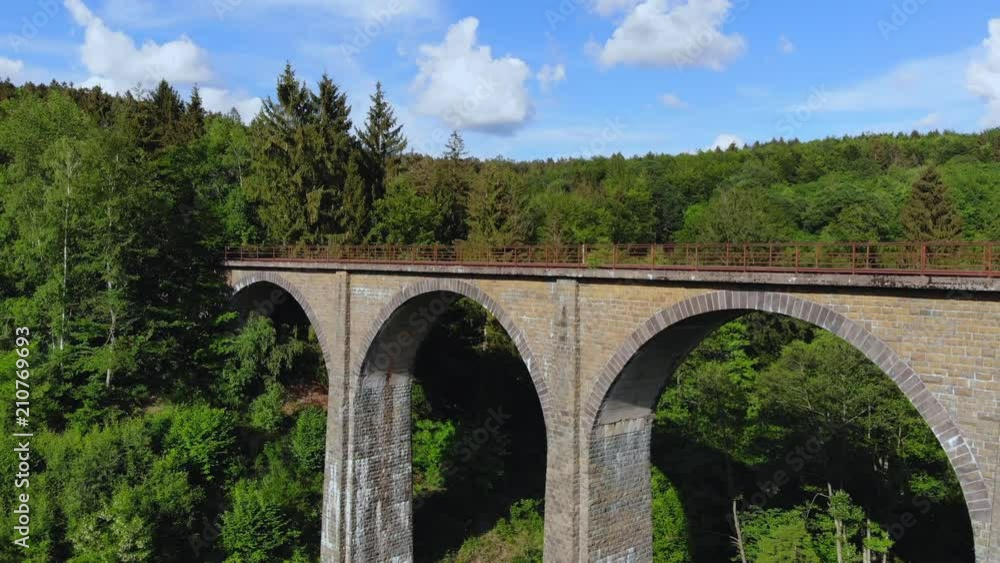 Railway overpass in the forest hills - aerial view over an old viaduct Railway overpass in the forest hills - aerial view over an old viaduct
