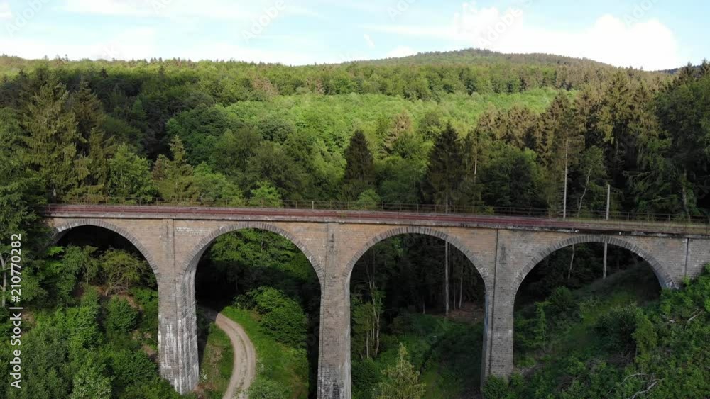 Railway overpass in the forest hills - aerial view over an old viaduct Railway overpass in the forest hills - aerial view over an old viaduct