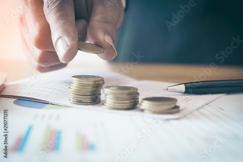  Man hand putting Row and coin stack growing business