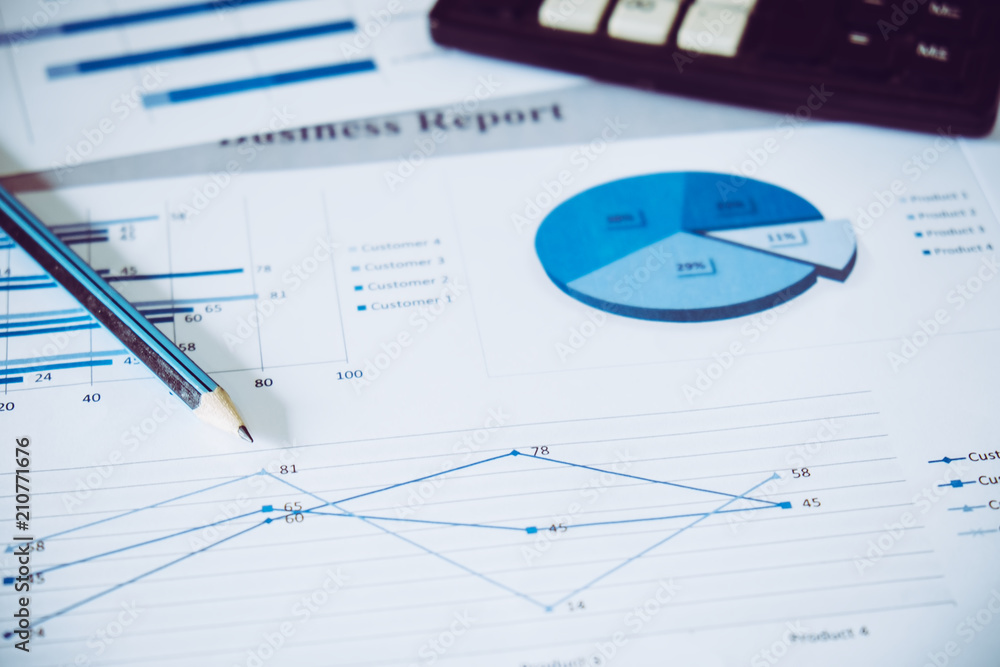 Many charts and graphs with pencil. Reflection light and flare. Concept image of data gathering and statistical working. Many charts and graphs with pencil. Reflection light and flare. Concept image of data gathering and statistical working.