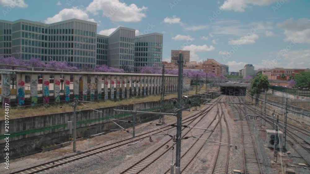 Left to right pan of multiple train tracks in Seville, Spain, on a beautiful summer day Left to right pan of multiple train tracks in Seville, Spain, on a beautiful summer day