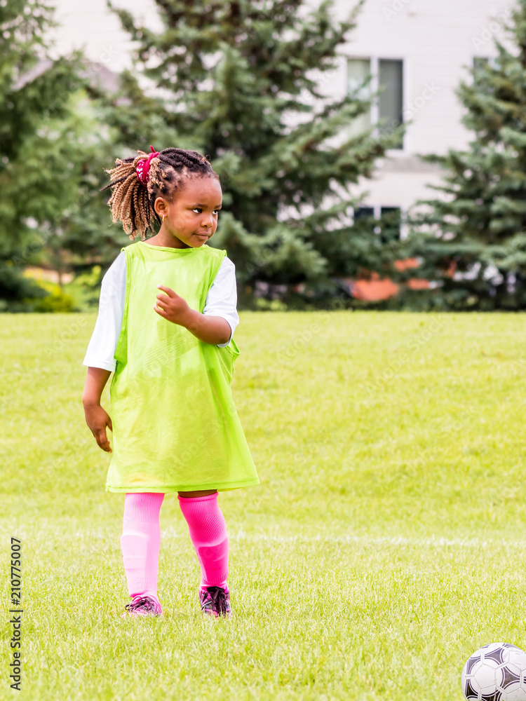 A young girl is learning how to play soccer A young girl is learning how to play soccer