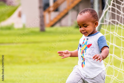 Canvastavla A close portrait of an African toddler enjoying a sunny day alone