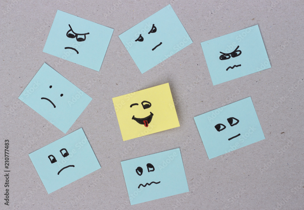 Unhappy smilies and a happy face painted on office stickers Unhappy smilies and a happy face painted on office stickers