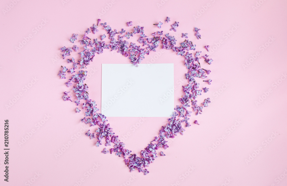 Heart of petals of flowers on a pink background, Valentine's Day, romantic concept.
