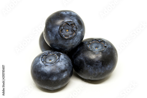 Three blueberries macro isolated on white background