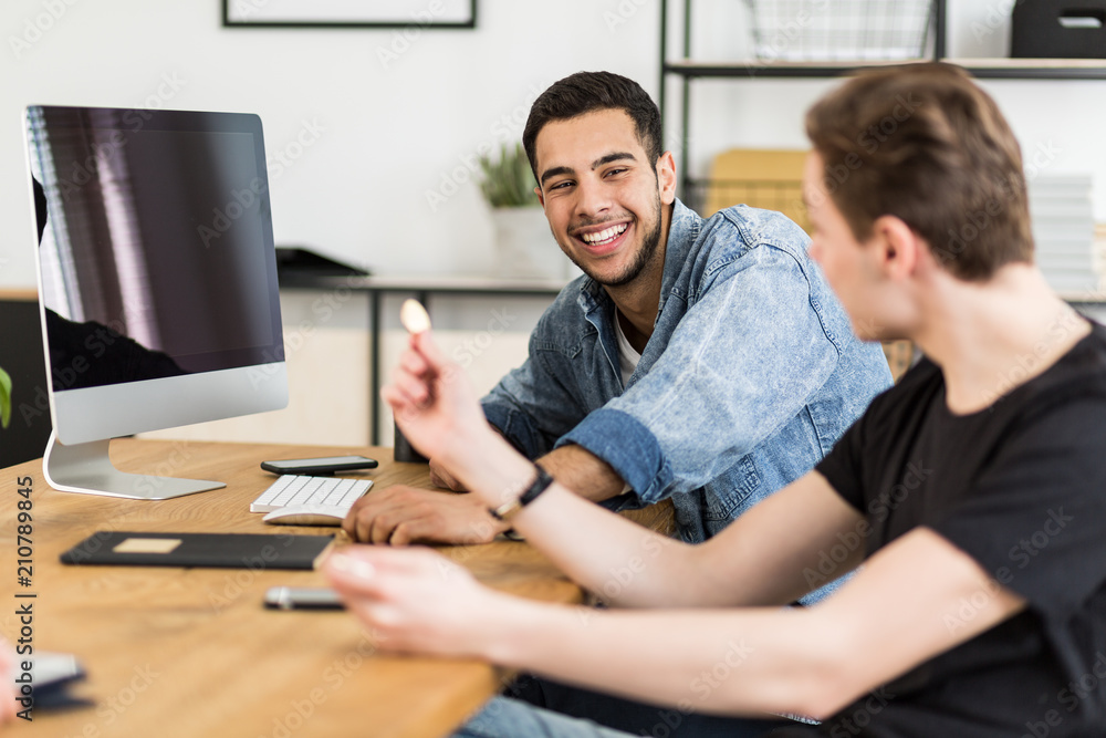 Smiling man and his friend running e-business with cryptocurrency BitCoin Smiling man and his friend running e-business with cryptocurrency BitCoin