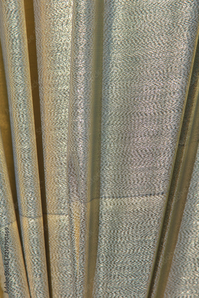 Golden fabric on the curtains as a background Golden fabric on the curtains as a background
