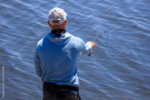 The fisherman is fishing on the lake photo