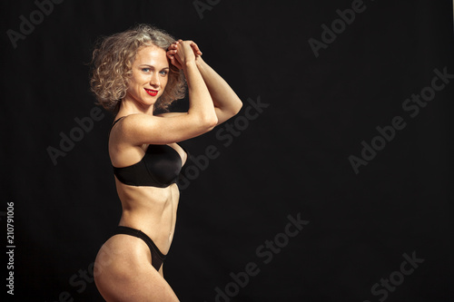 Young beautiful girl naked isolated on a black background