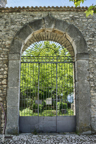 Medieval arched entrance with iron gate
