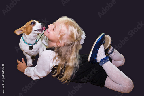 little girl is playing with Jack Russell photo