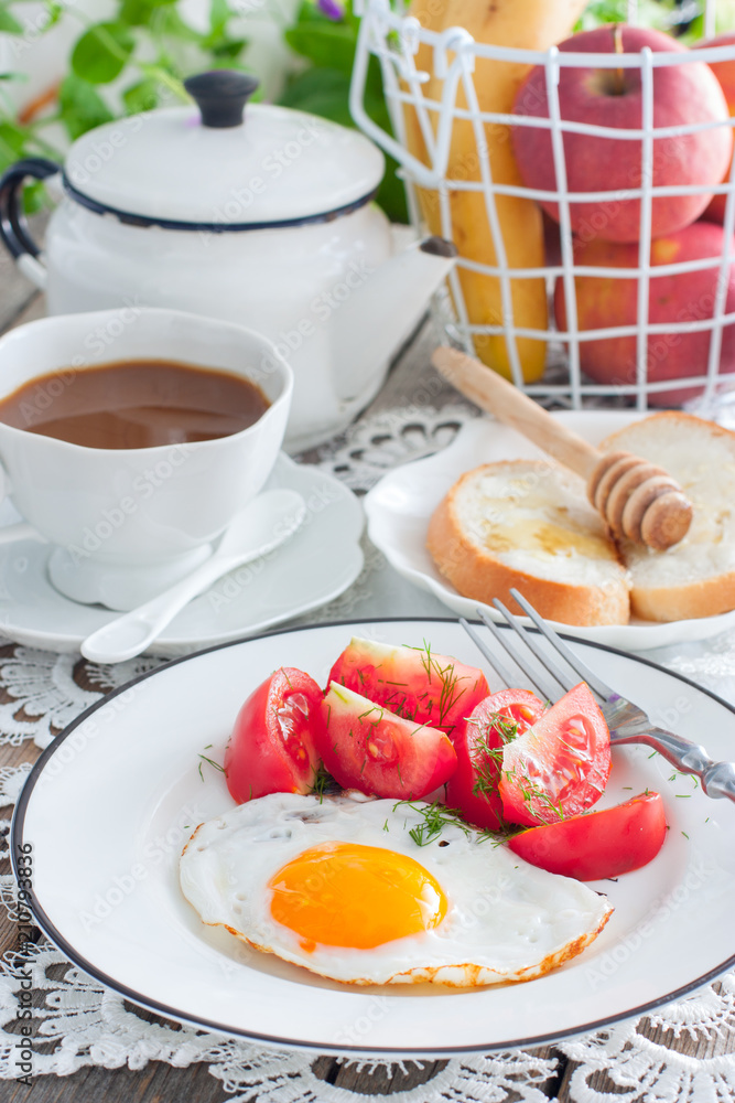 Breakfast of scrambled eggs, fresh tomatoes, coffee with milk, bread with honey, selective focus Breakfast of scrambled eggs, fresh tomatoes, coffee with milk, bread with honey, selective focus