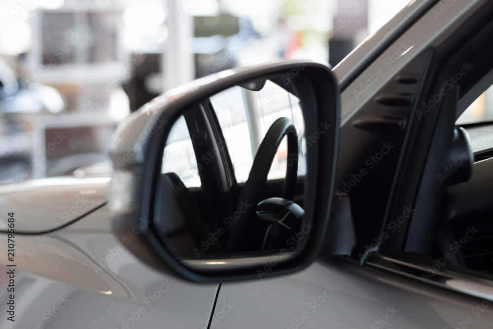 Reflection in side mirror of the car steering wheel. Modern transportation.
