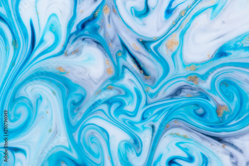 Marbled unique blue abstract background with gold dust. Flowing liquid marble texture.