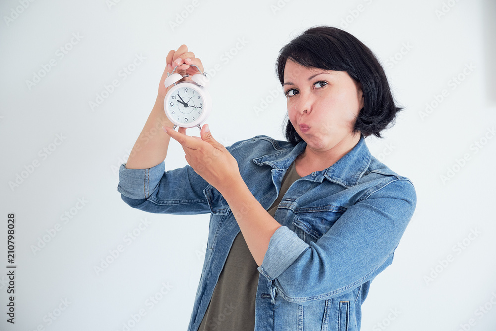 surprised young woman with clock wondering eyes. stressed concept surprised young woman with clock wondering eyes. stressed concept