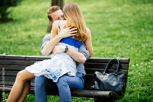 Dating couple sitting on bench