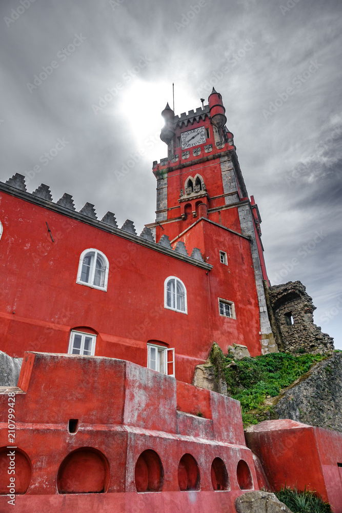 Obraz premium Palace da Pena tower over hill and sun