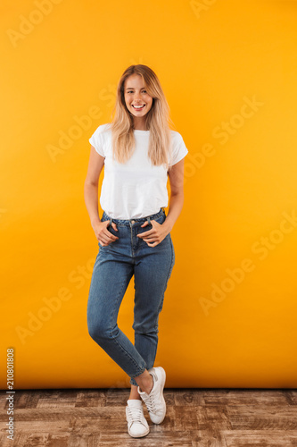 Full length portrait of a smiling young blonde girl