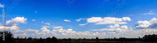 A curly summer clouds on blue sky background