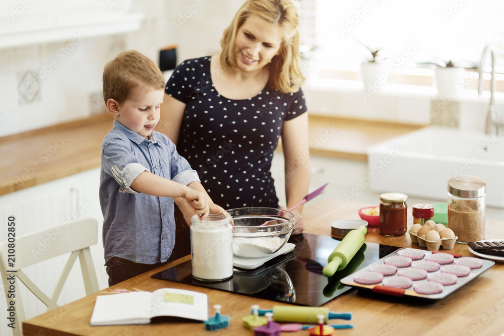 Mother and child preparing cookies Mother and child preparing cookies