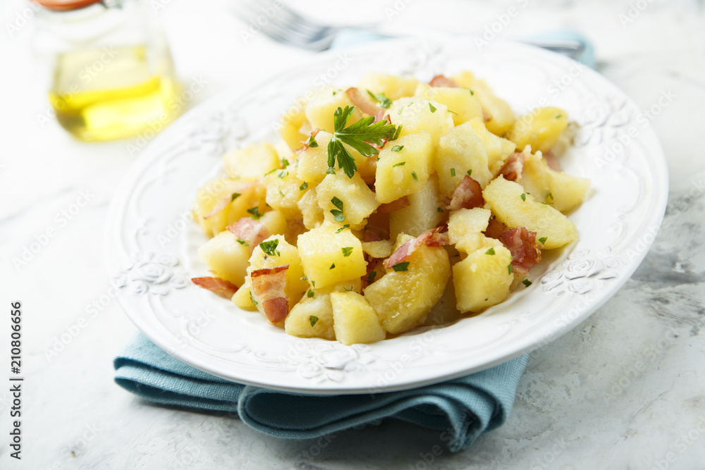 Homemade warm potato salad with onion and fried bacon Homemade warm potato salad with onion and fried bacon