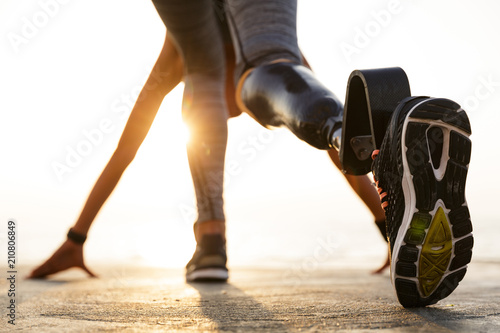 Back view of disabled athlete woman with prosthetic leg