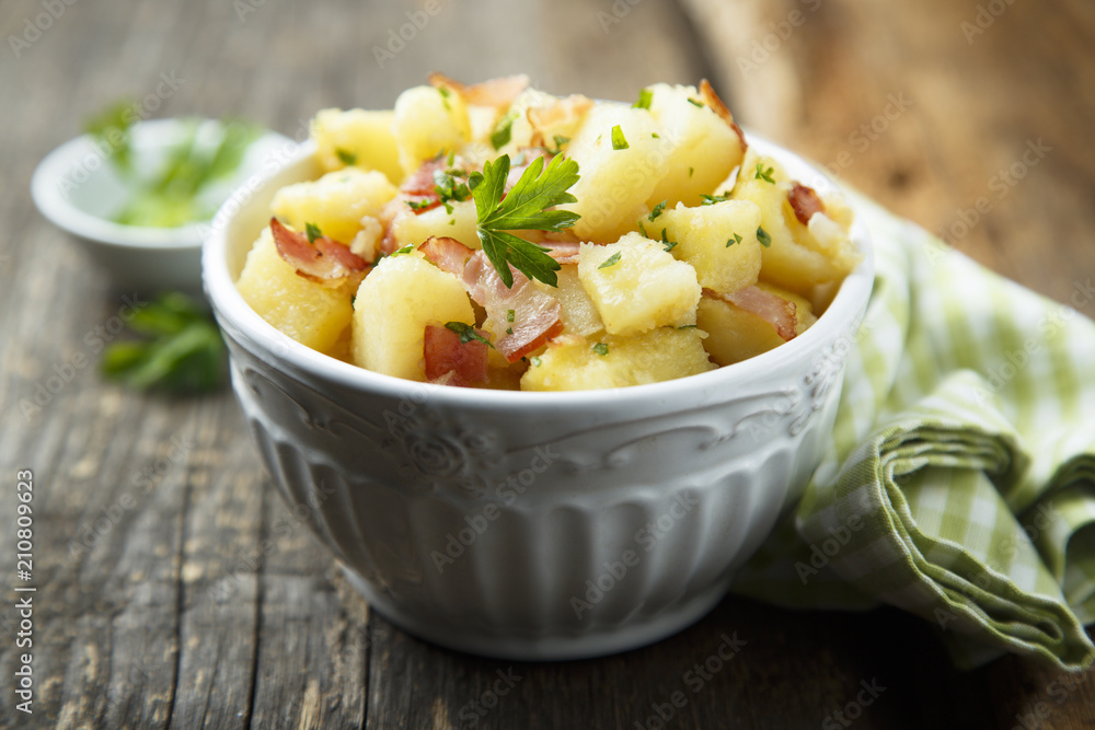 Homemade warm potato salad with onion and fried bacon Homemade warm potato salad with onion and fried bacon