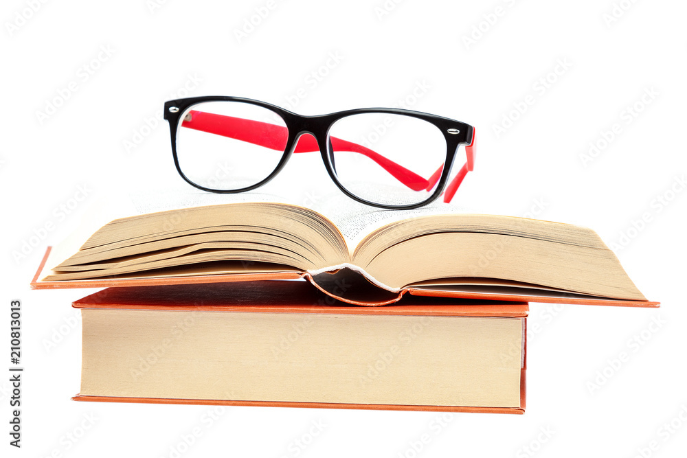 Open book and glasses on a stack of books Open book and glasses on a stack of books