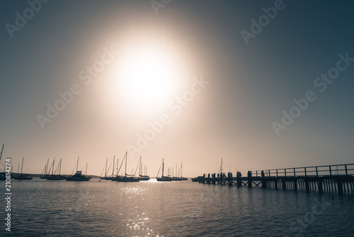 Yachts and wooden jetty at the sea