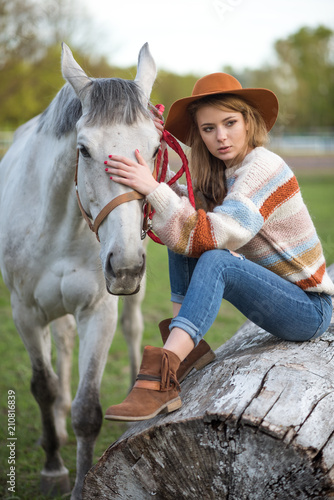 Beautiful Portrait Of Woman With Horse. Girl hugging a horse.A beautiful blonde girl enjoys life and nature. © Iulia