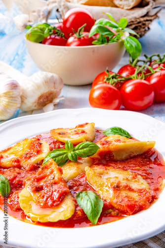 Delicious pasta - ravioli in tomato sauce with basil