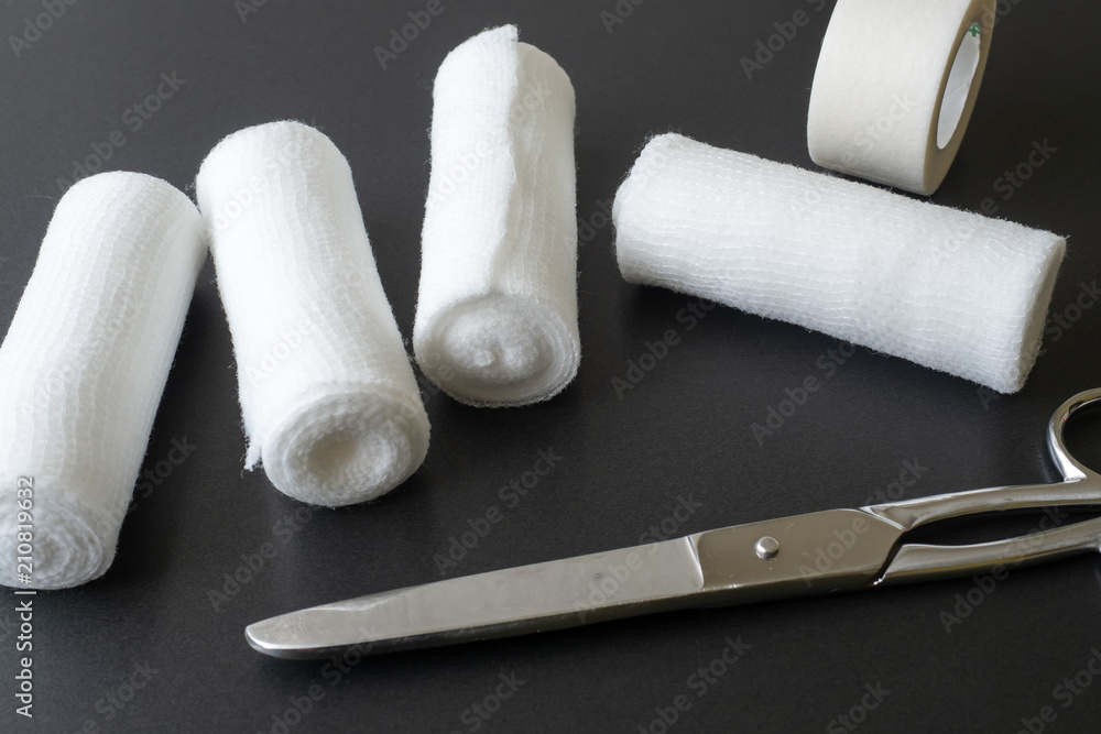 Obraz premium Medical bandages with scissors and sticking plaster. Medical equipment.