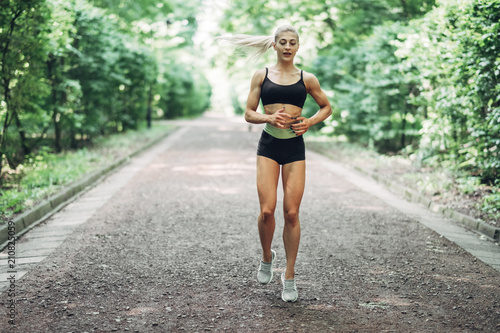 Young Woman Running. Beautiful fit Girl. Fitness model outdoors. Weight Loss.
