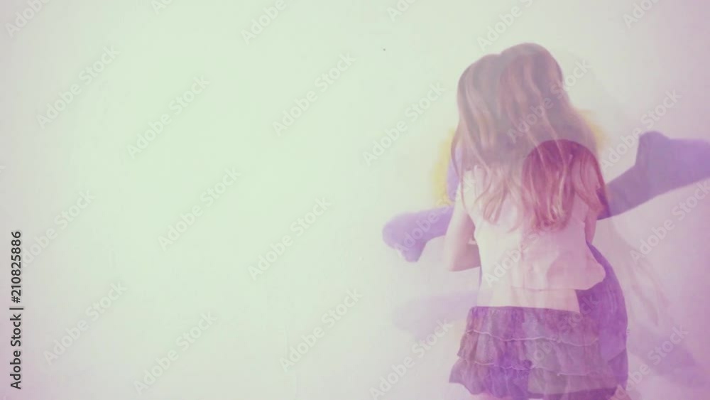 Girl jumping while hugging a stuffed animal in slow motion Girl jumping while hugging a stuffed animal in slow motion