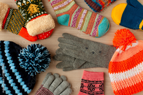Autumn and winter clothes. Scattered warm clothes like hats, mittens, gloves and socks. Warm clothes for cold seasons. View from above.