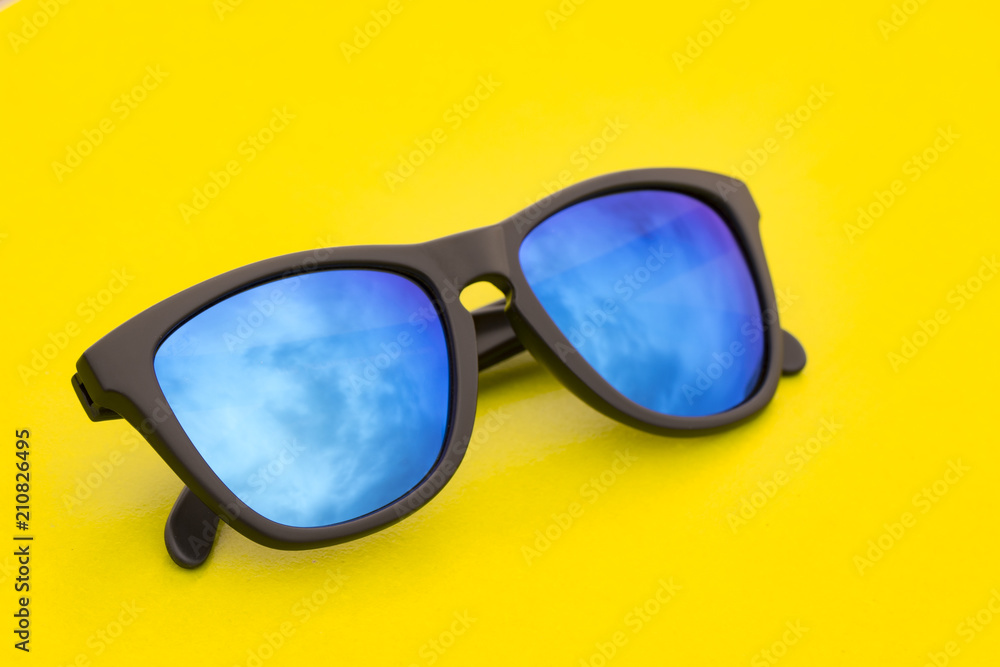 Image of modern fashionable sunglasses on yellow background, Glasses.
