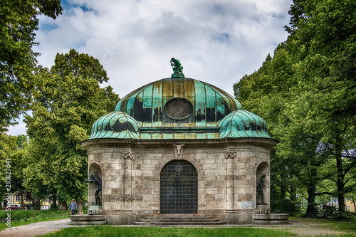 Munich, Germany - June 09, 2018: Hubertusbrunnen. Hubertusbrunnen is a fountain complex in the west of Munich. It is located at the eastern end of the Nymphenburger canal, north of the Grünwaldpark. photo