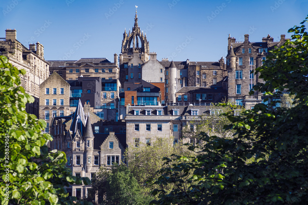 A view of Edinburgh Old Town, as seen from the famous Princes Street Gardens.  Scotland, UK.  The spire in the centre of the skyline is St Giles Cathedral.