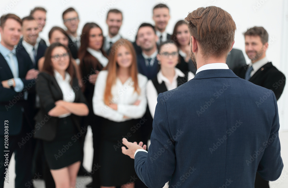 businessman makes a speech to his large business team businessman makes a speech to his large business team